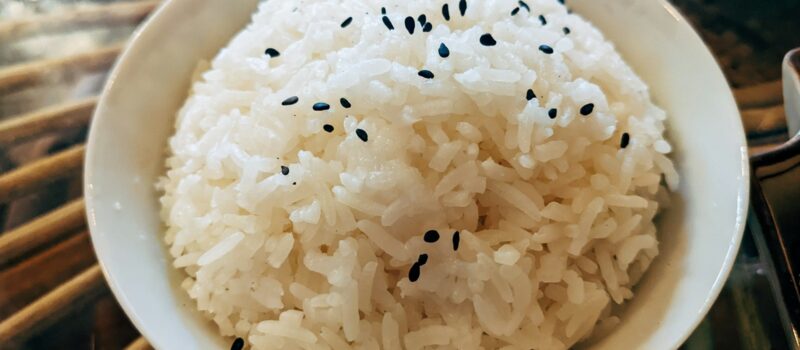 a bowl of white rice with black sesame seeds